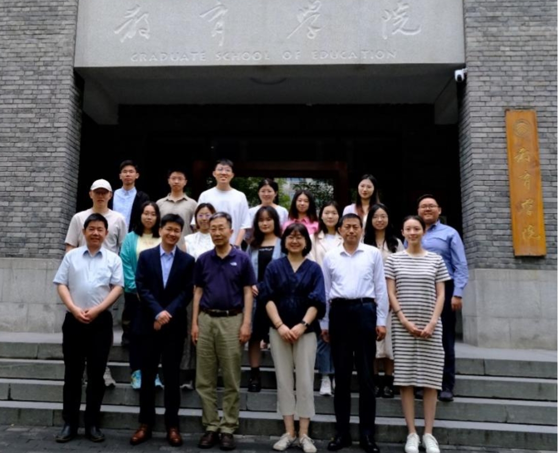 A group of people standing in front of a building

Description automatically generated